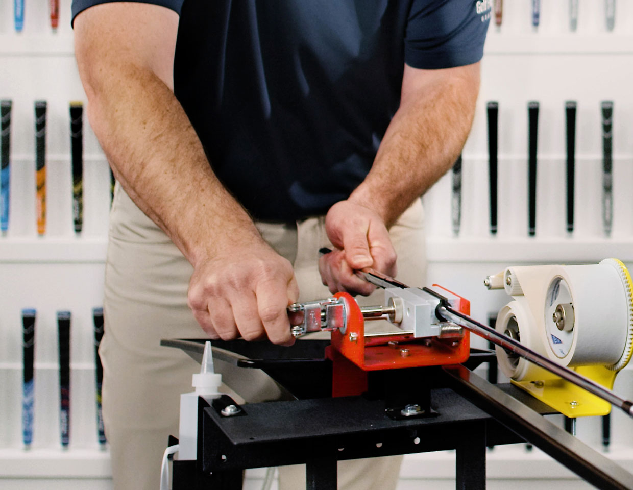 a man regripping his own clubs